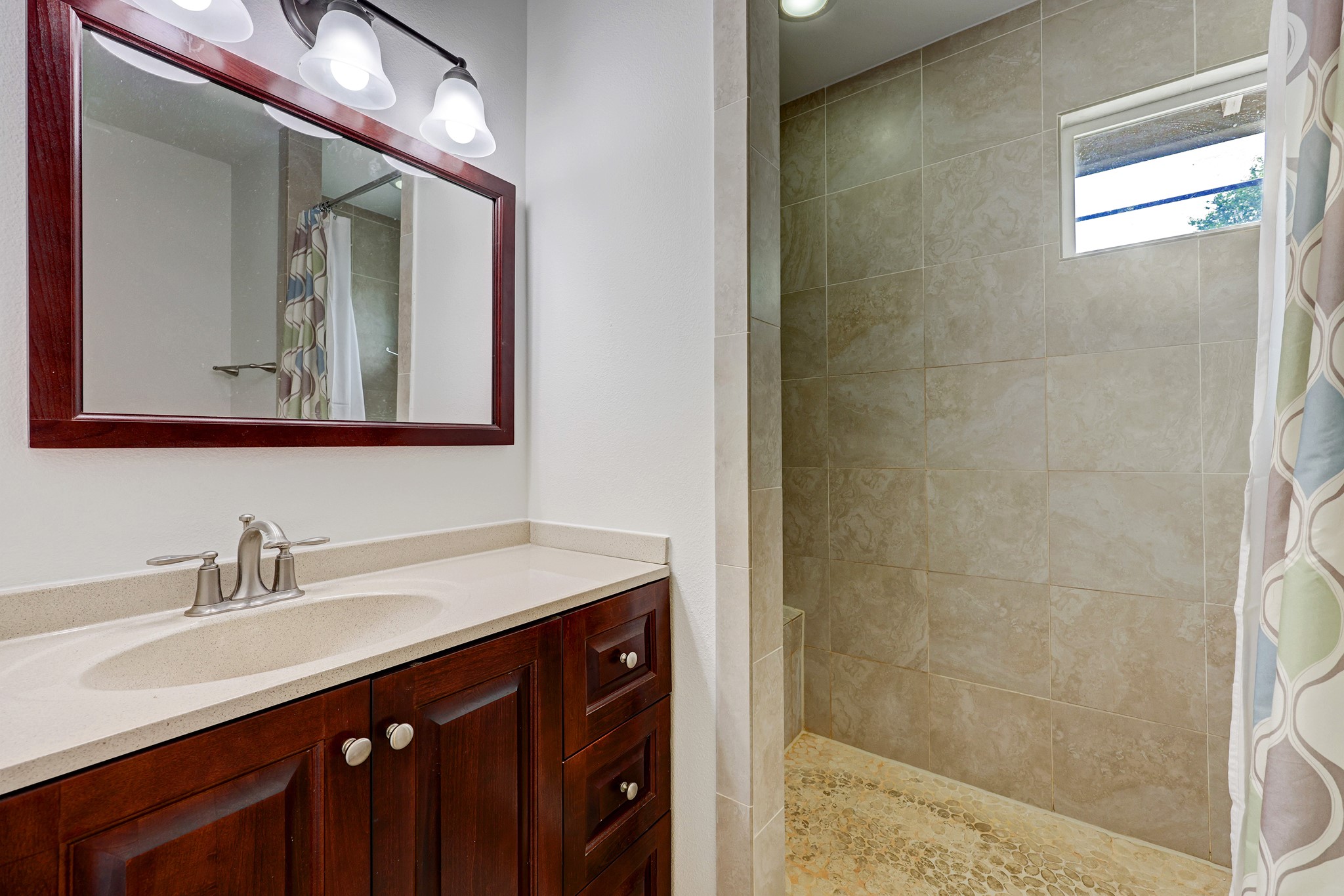 1800 Deloney Street Austin, TX 78721 - Photo 16 of 25 a bathroom with a sink vanity and a mirror