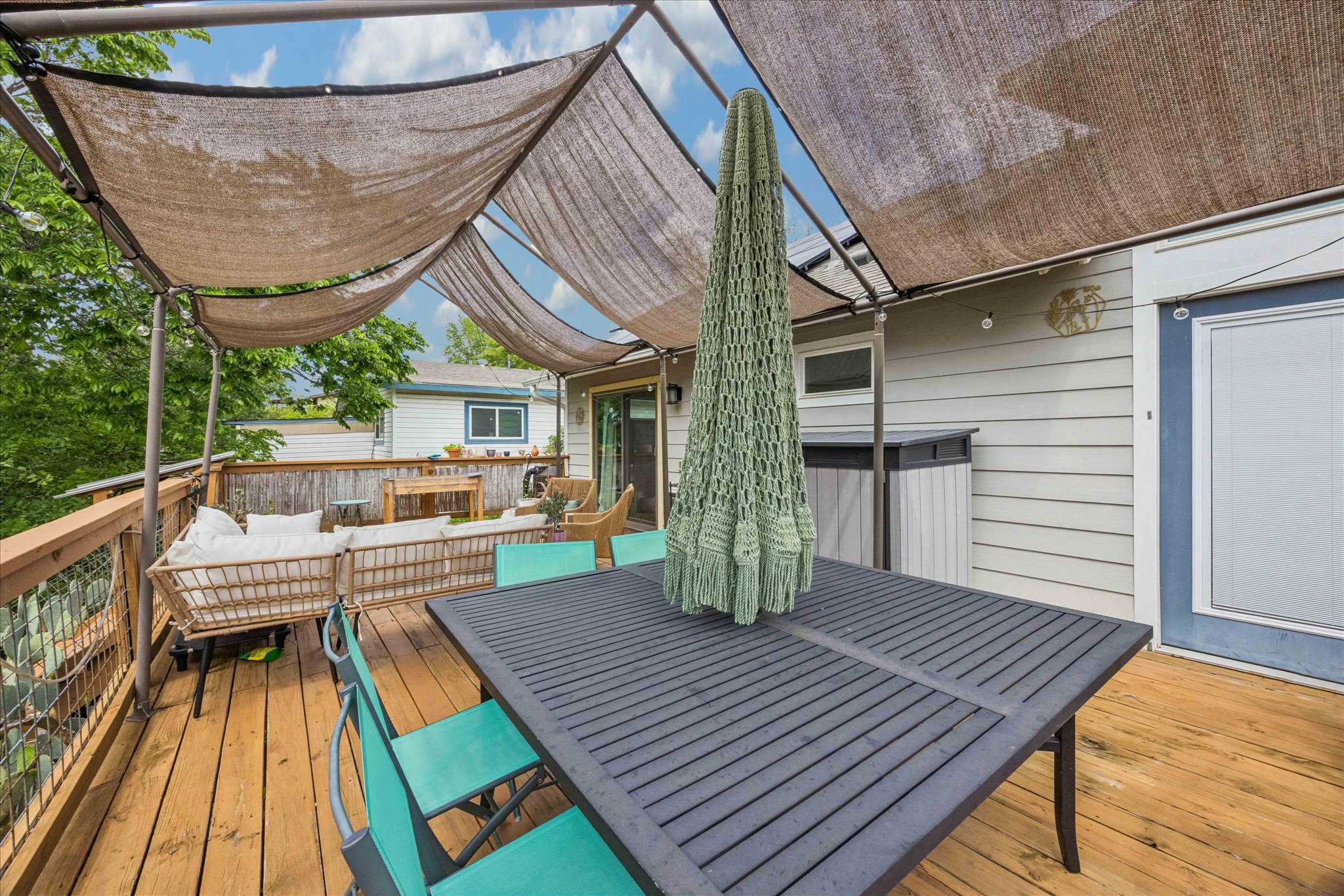 1800 Deloney Street Austin, TX 78721 - Photo 18 of 25 a view of deck with table and chairs wooden floor and a barbeque