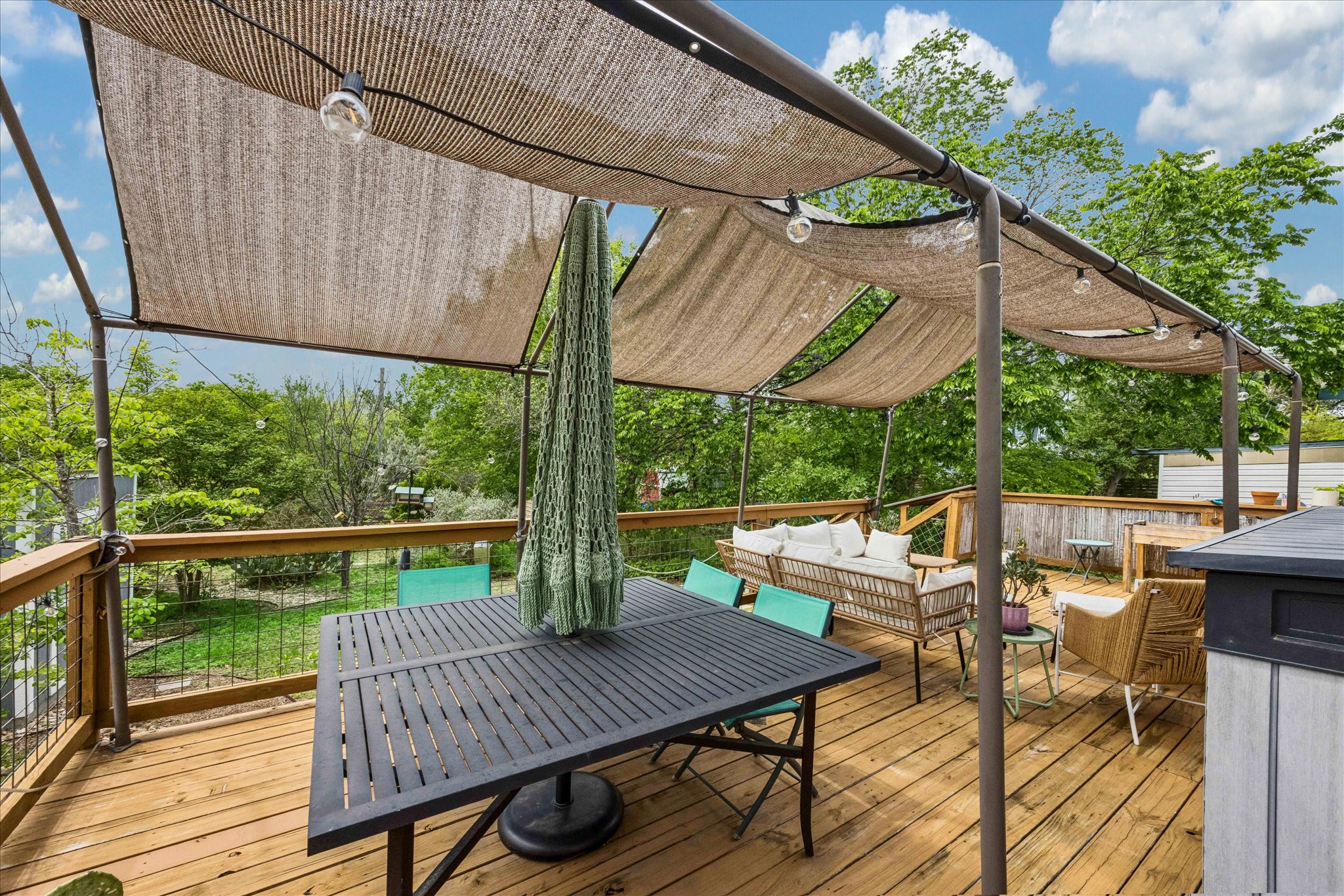 1800 Deloney Street Austin, TX 78721 - Photo 20 of 25 a view of a patio with table and chairs under an umbrella with wooden floor