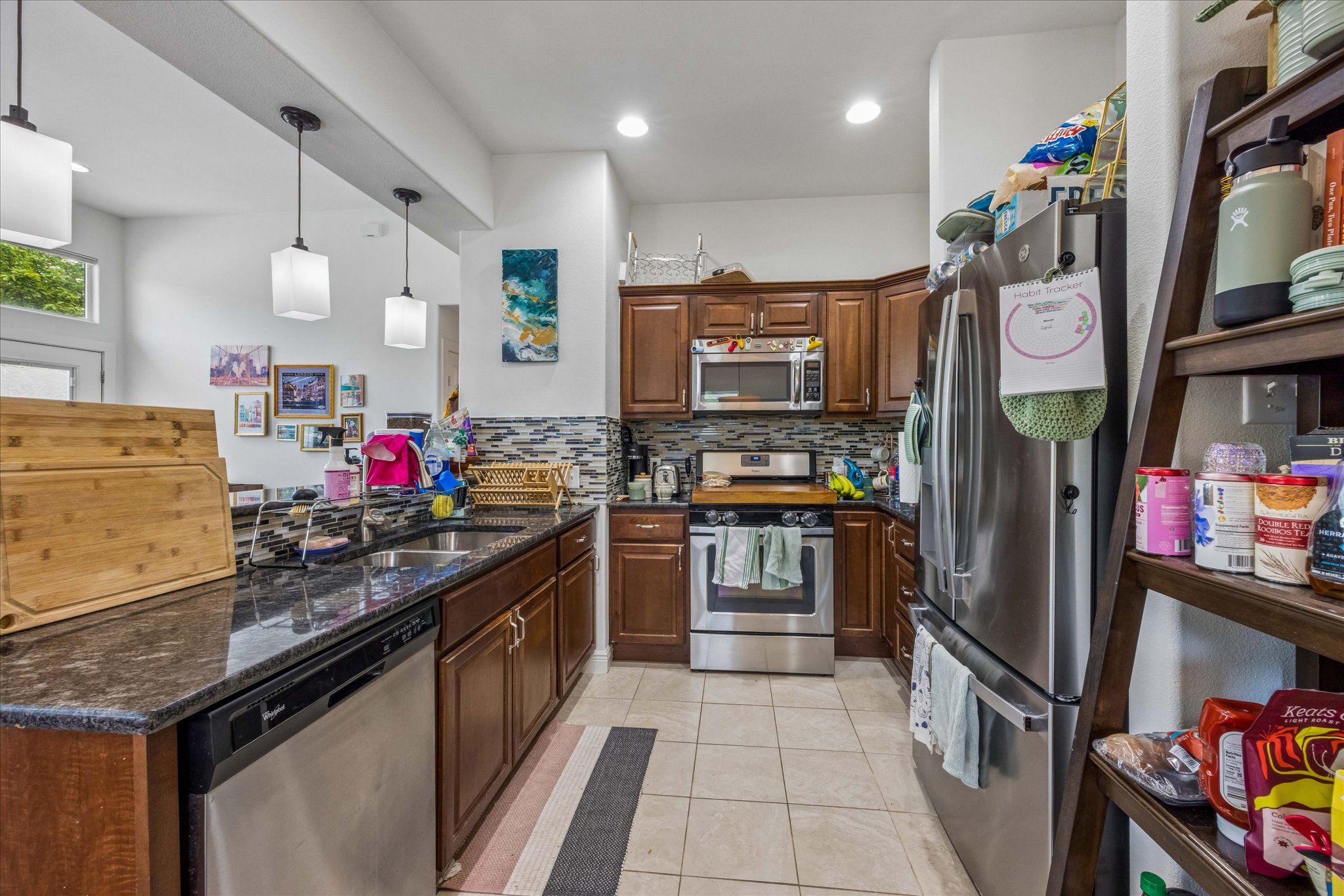 1800 Deloney Street Austin, TX 78721 - Photo 10 of 25 a kitchen with stainless steel appliances granite countertop a refrigerator and a stove