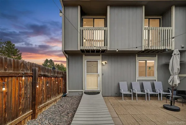a backyard of a house with table and chairs