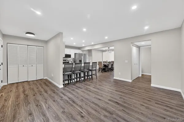 a view of an empty room with wooden floor