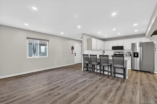 a view of kitchen with refrigerator microwave and wooden floor
