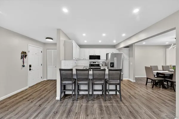 a view of a dining room with furniture and wooden floor
