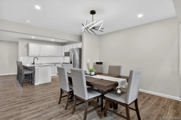 a view of a dining room with furniture and wooden floor