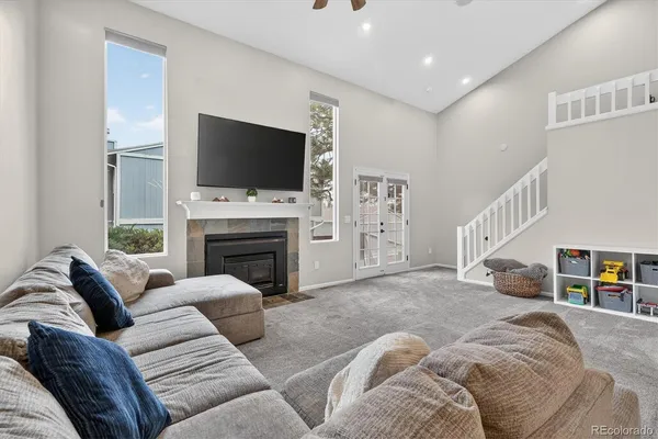 a living room with furniture a flat screen tv and a fireplace