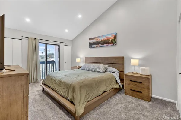 a bedroom with a bed and a night stand