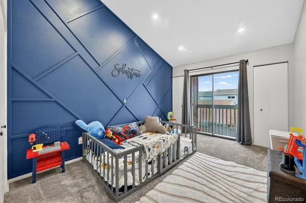 a bedroom with furniture and a baby crib