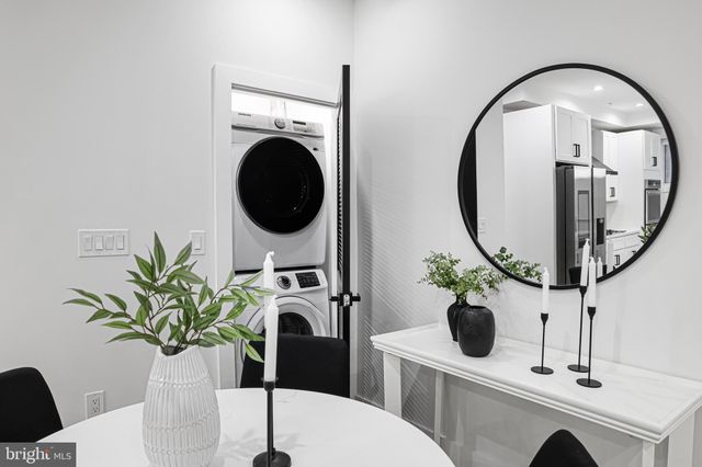a dining room with furniture potted plants and wooden floor