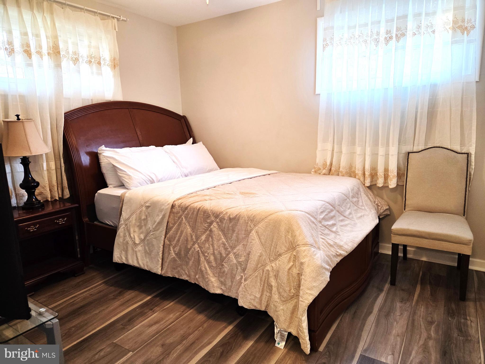 7613 Wilhelm Avenue Rosedale, MD 21237 - Photo 12 of 96 a bedroom with a bed and wooden floor