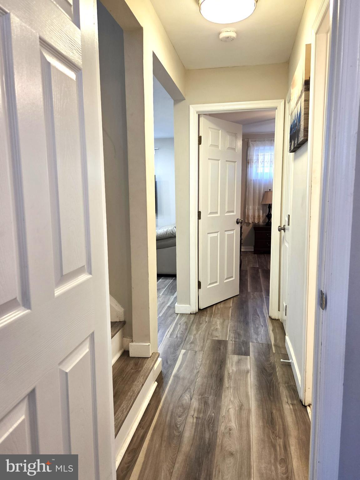 7613 Wilhelm Avenue Rosedale, MD 21237 - Photo 17 of 96 a view of a hallway with wooden floor and staircase