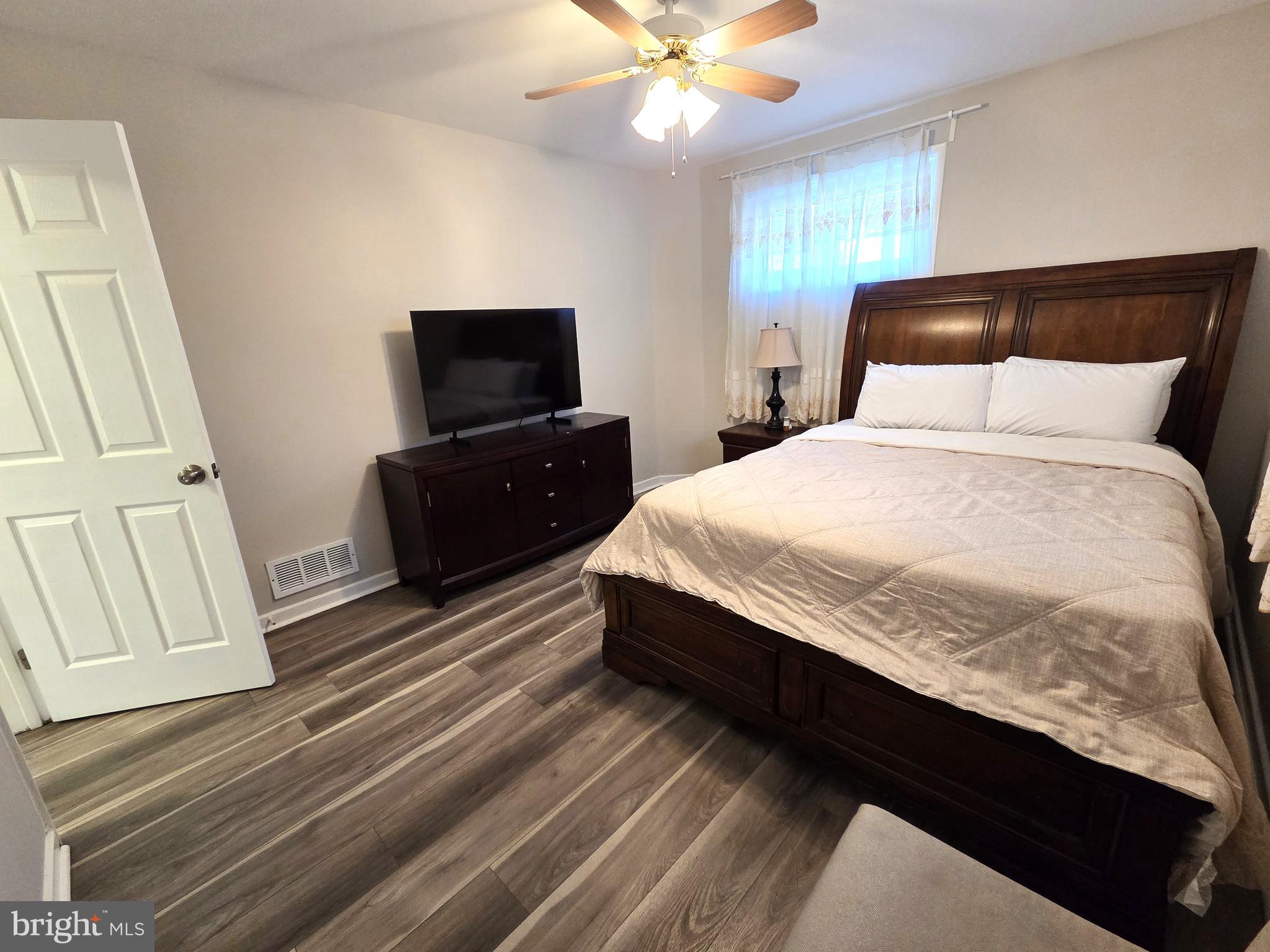 7613 Wilhelm Avenue Rosedale, MD 21237 - Photo 26 of 96 a bedroom with a bed and a flat screen tv