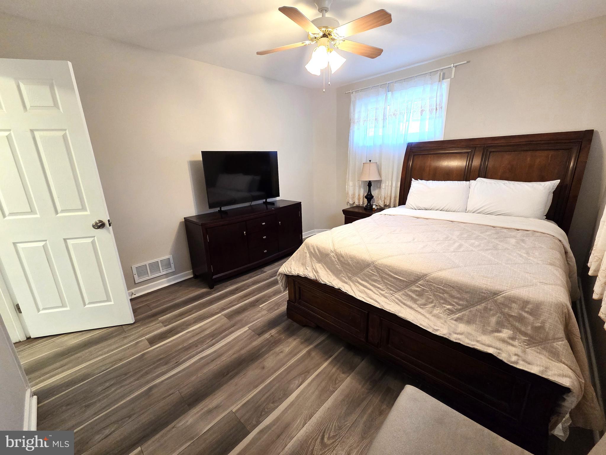 7613 Wilhelm Avenue Rosedale, MD 21237 - Photo 27 of 96 a bedroom with a bed and a flat tv screen on dresser