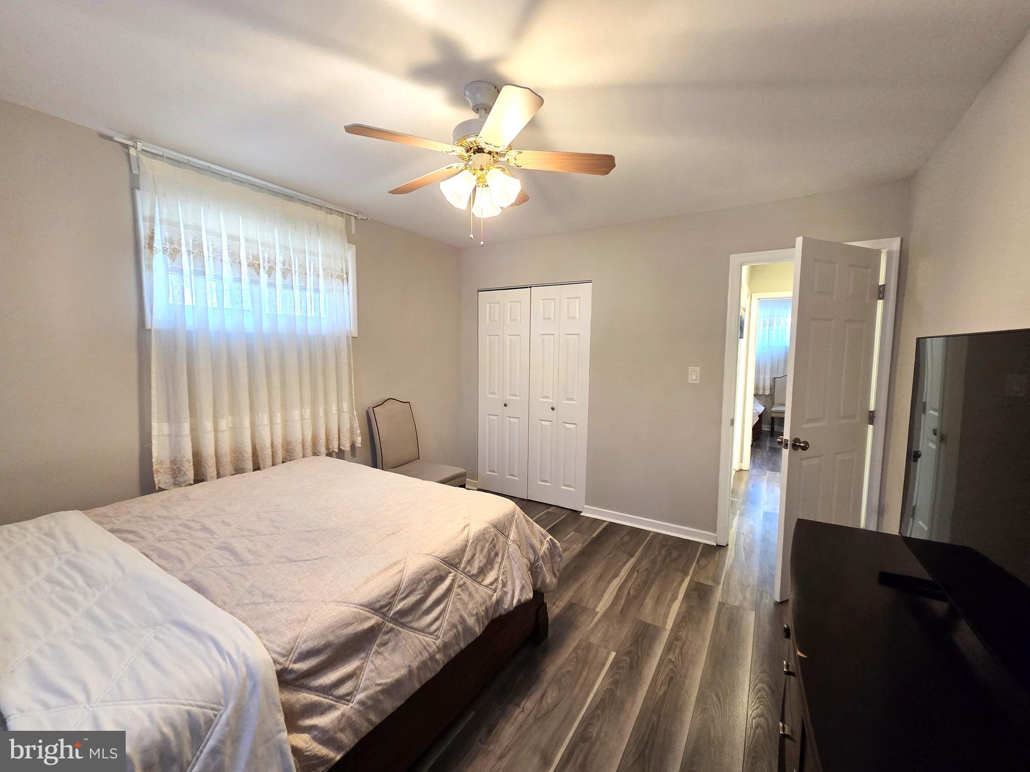 7613 Wilhelm Avenue Rosedale, MD 21237 - Photo 29 of 96 a bedroom with a bed and a chandelier