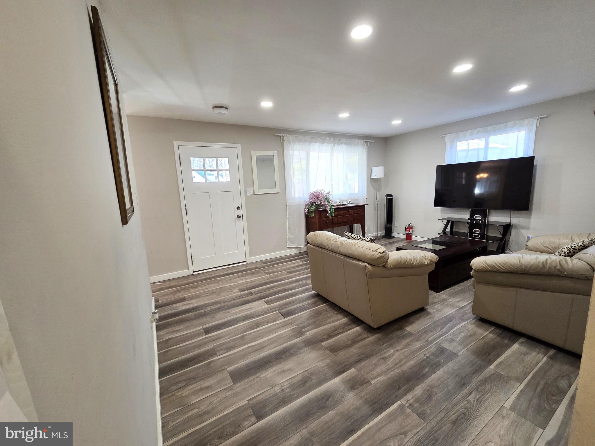 7613 Wilhelm Avenue Rosedale, MD 21237 - Photo 31 of 96 a living room with furniture and a flat screen tv