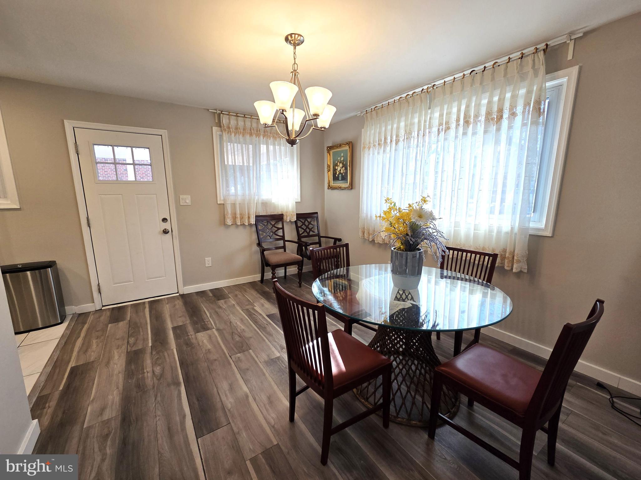 7613 Wilhelm Avenue Rosedale, MD 21237 - Photo 44 of 96 a view of a dining room with furniture and chandelier