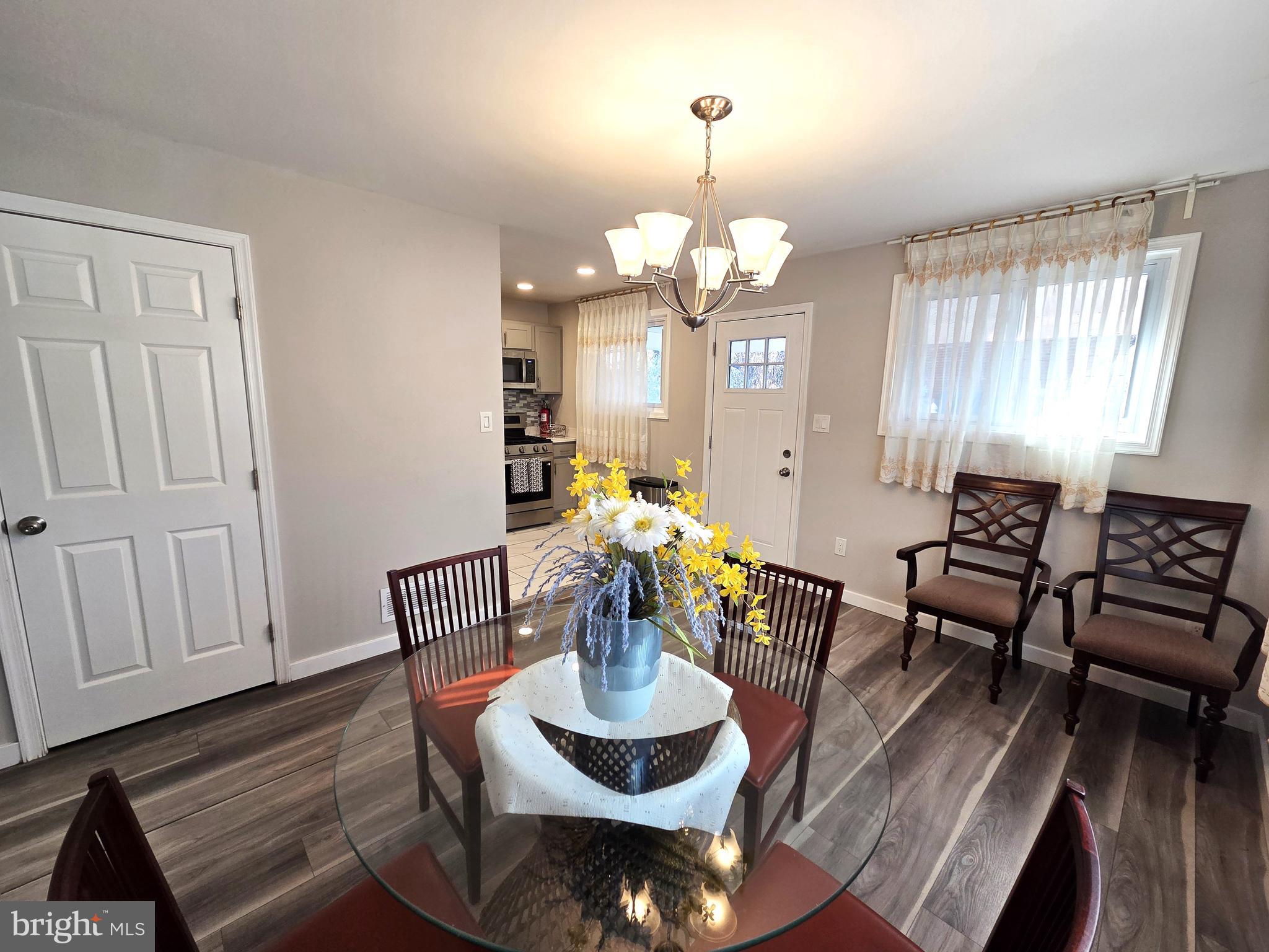 7613 Wilhelm Avenue Rosedale, MD 21237 - Photo 46 of 96 a living room with furniture a window and dining table