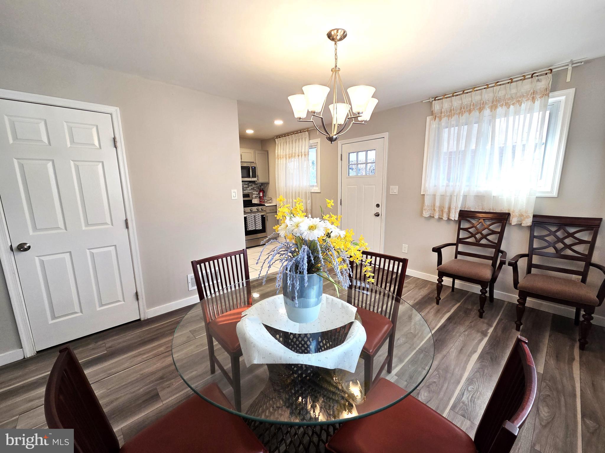 7613 Wilhelm Avenue Rosedale, MD 21237 - Photo 47 of 96 a view of a dining room with furniture a chandelier and wooden floor