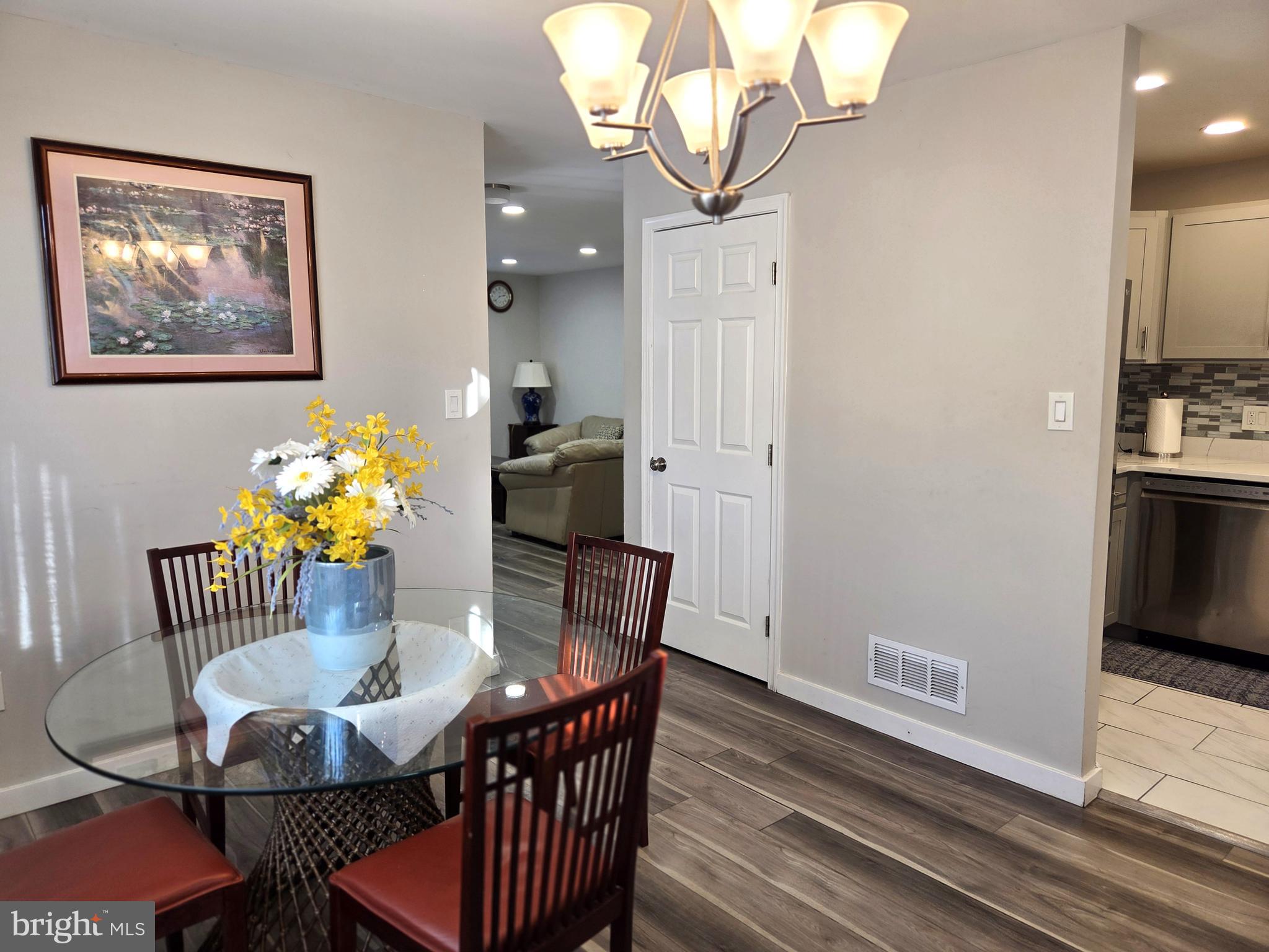 7613 Wilhelm Avenue Rosedale, MD 21237 - Photo 48 of 96 a view of a dining room with furniture wooden floor and a chandelier