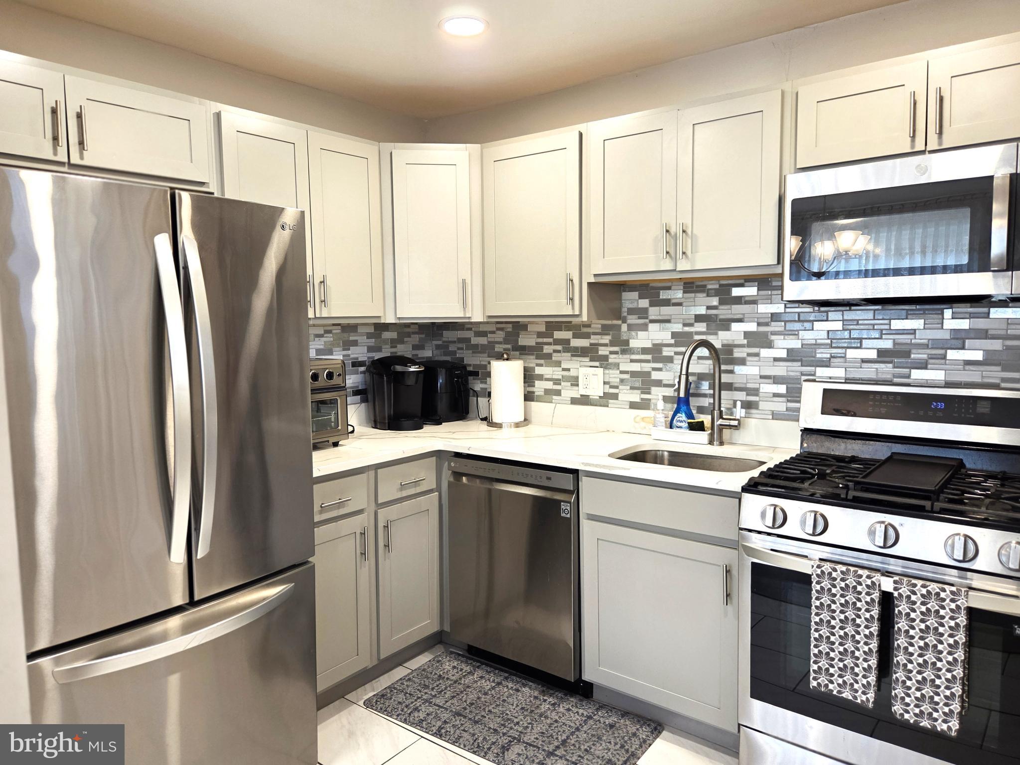 7613 Wilhelm Avenue Rosedale, MD 21237 - Photo 51 of 96 a kitchen with a refrigerator stove and microwave