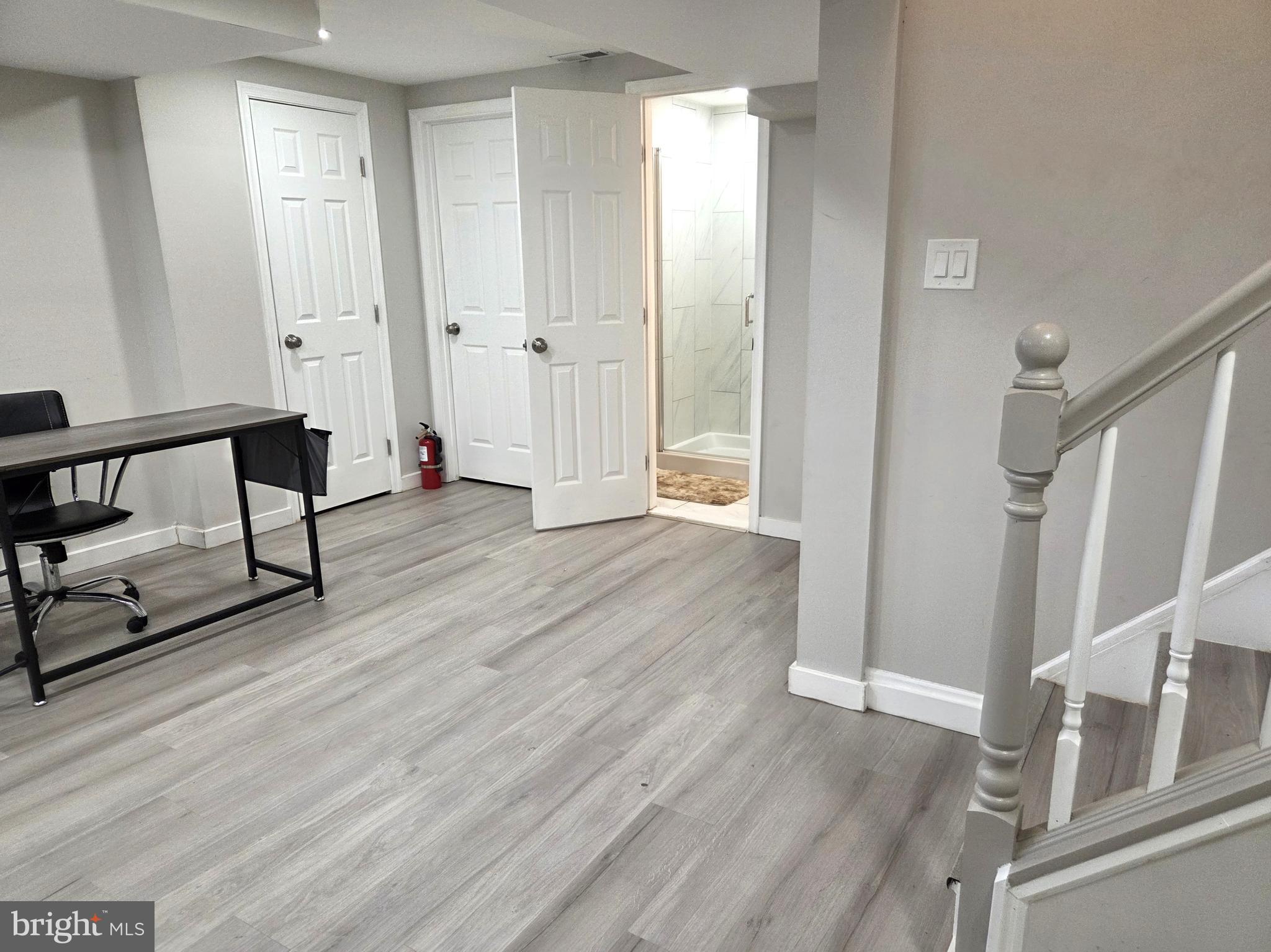 7613 Wilhelm Avenue Rosedale, MD 21237 - Photo 82 of 96 a view of a hallway with wooden floor and staircase