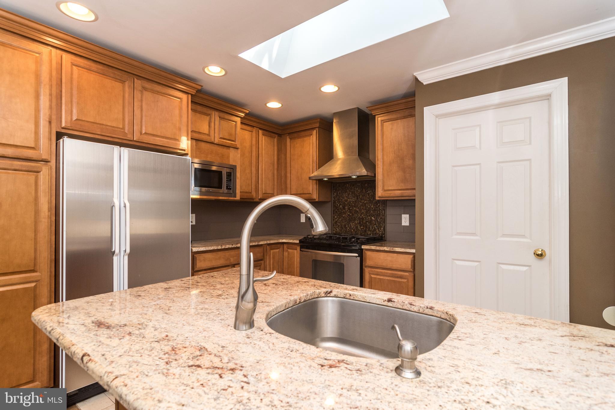 1306 Sylvan Road Perkasie, PA 18944 - Photo 15 of 47 a kitchen with granite countertop a sink refrigerator and cabinets