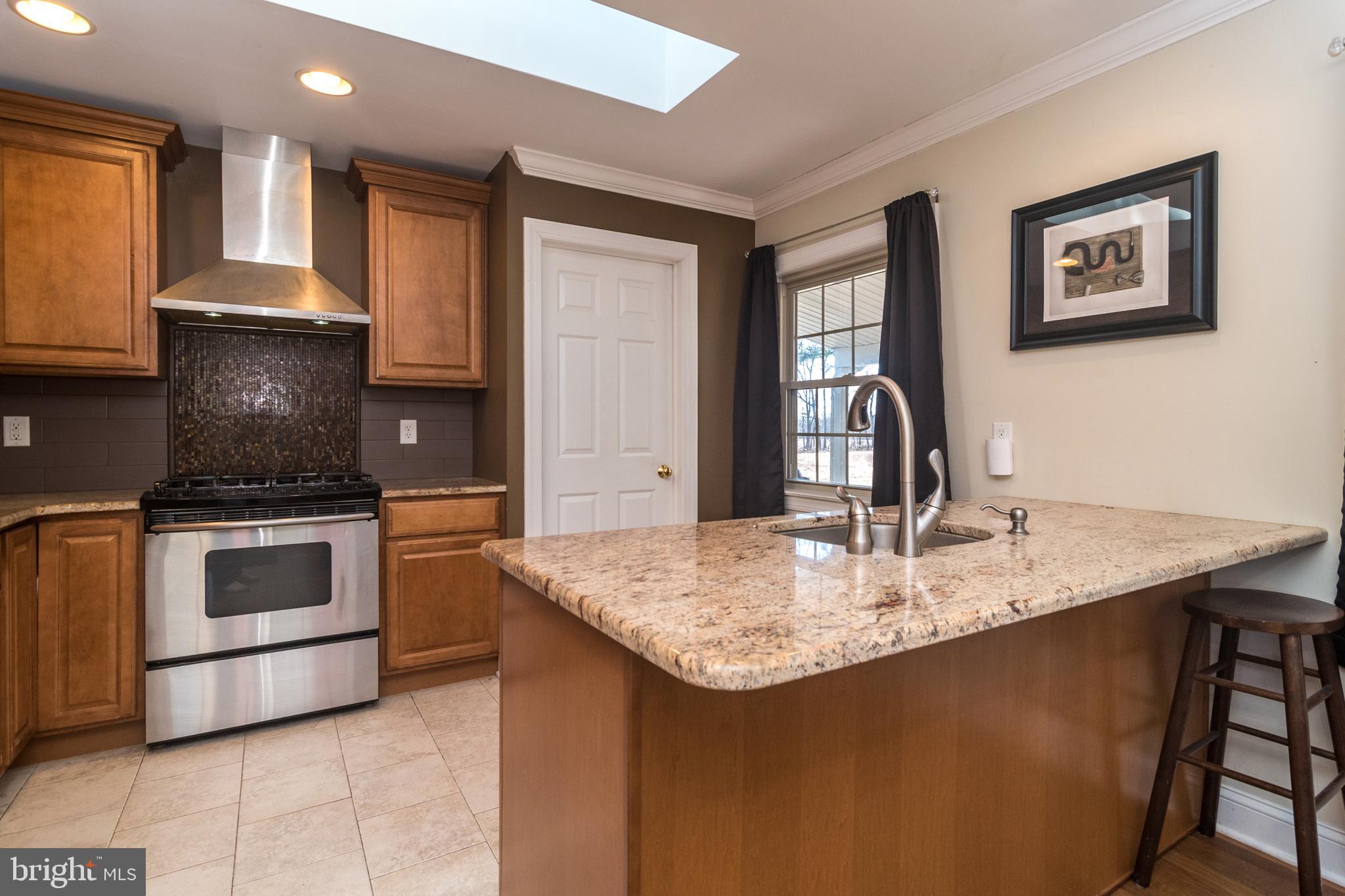 1306 Sylvan Road Perkasie, PA 18944 - Photo 16 of 47 a kitchen with kitchen island granite countertop a stove and a sink
