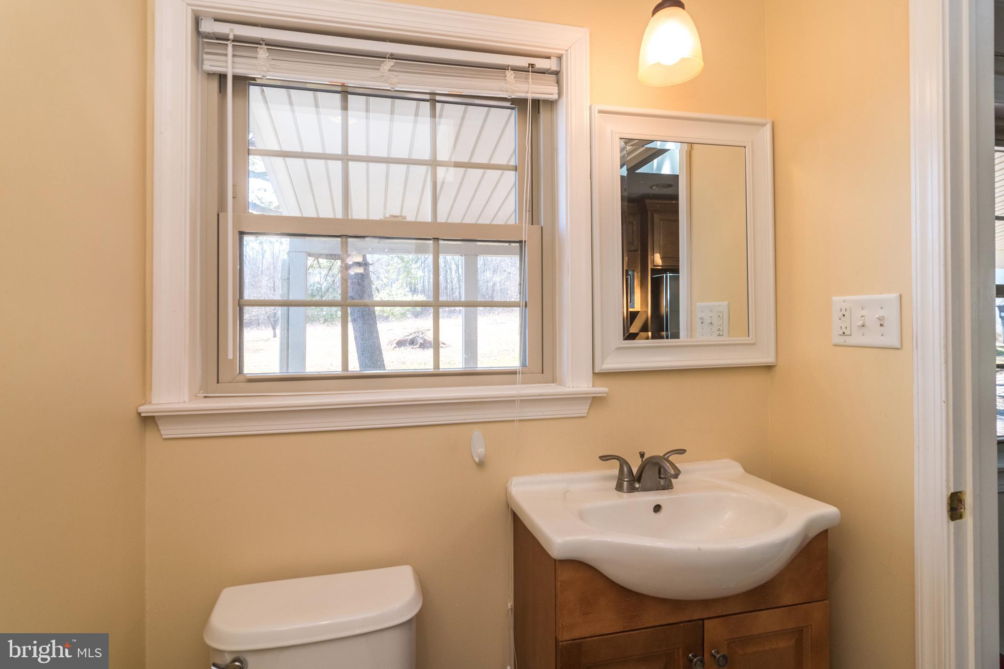 1306 Sylvan Road Perkasie, PA 18944 - Photo 22 of 47 a bathroom with a sink a toilet and a mirror