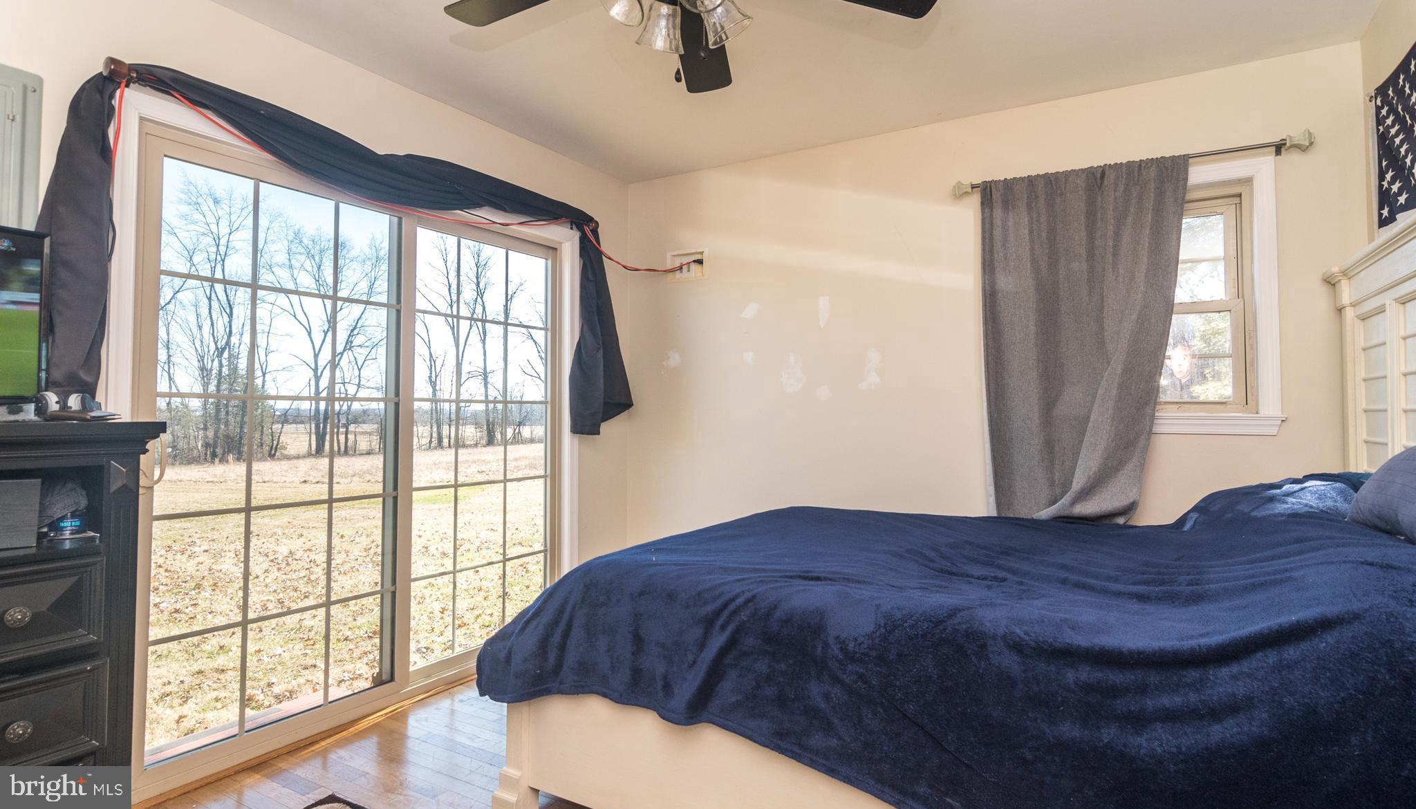 1306 Sylvan Road Perkasie, PA 18944 - Photo 27 of 47 a large bedroom with wooden floor and a window