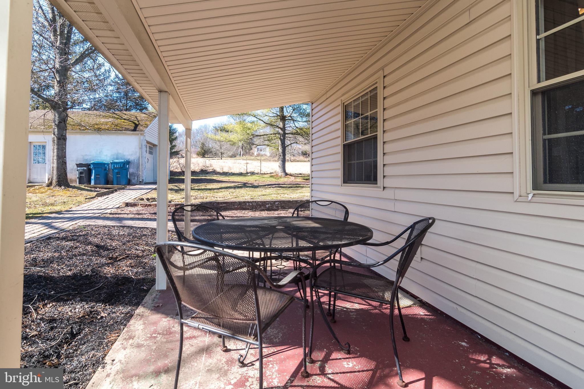 1306 Sylvan Road Perkasie, PA 18944 - Photo 29 of 47 a view of a patio with a table and chairs and couches