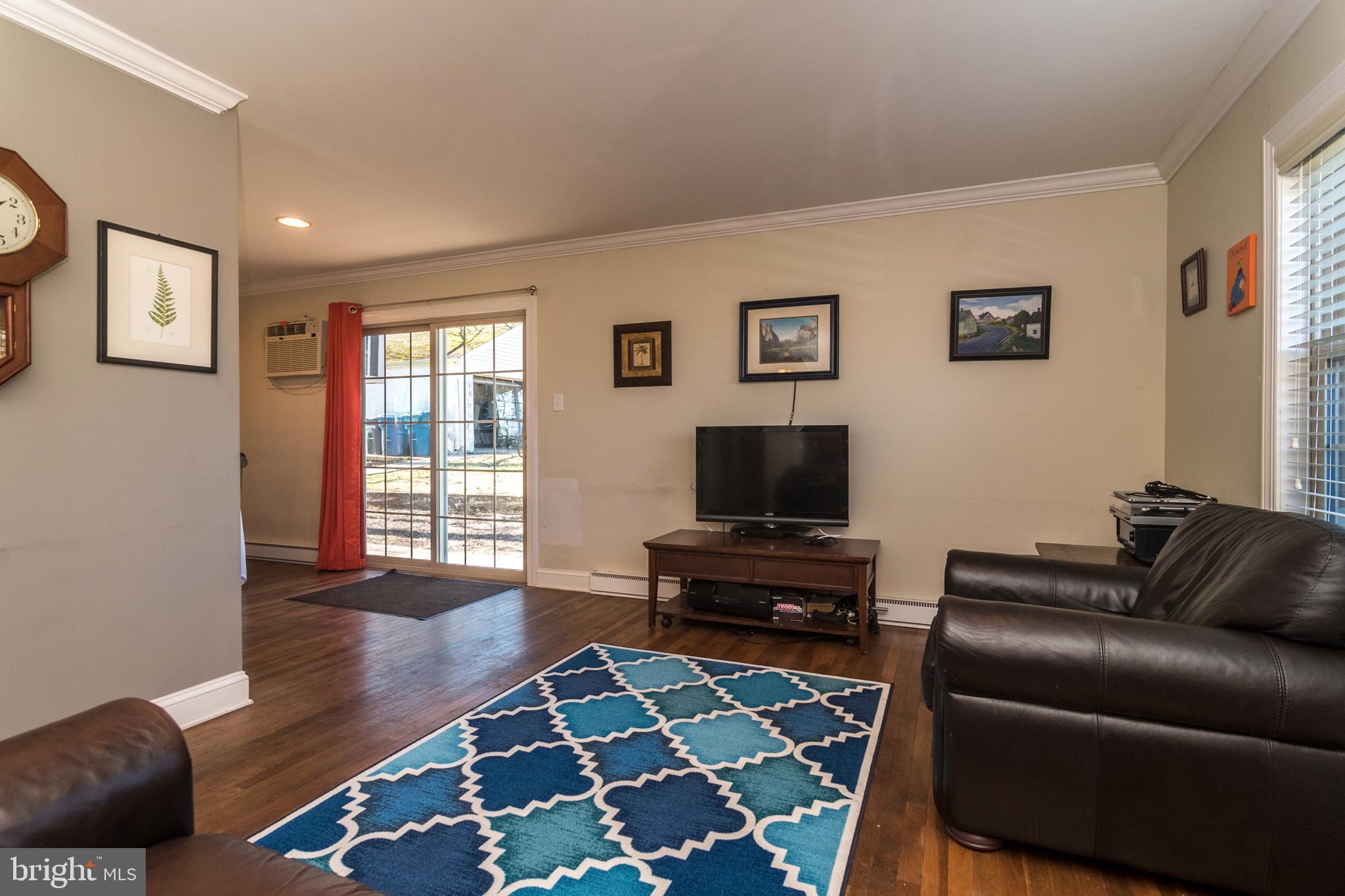 1306 Sylvan Road Perkasie, PA 18944 - Photo 10 of 47 a living room with furniture and a flat screen tv with wooden floor