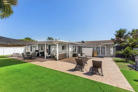 a view of a house with backyard sitting area and garden
