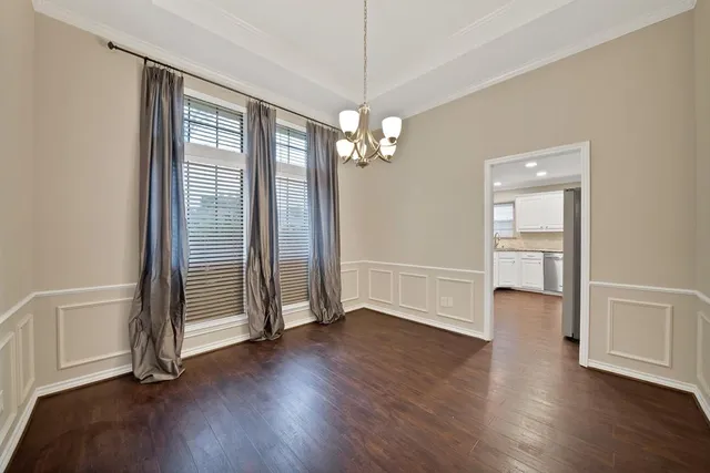 a view of a livingroom with wooden floor and a ceiling fan
