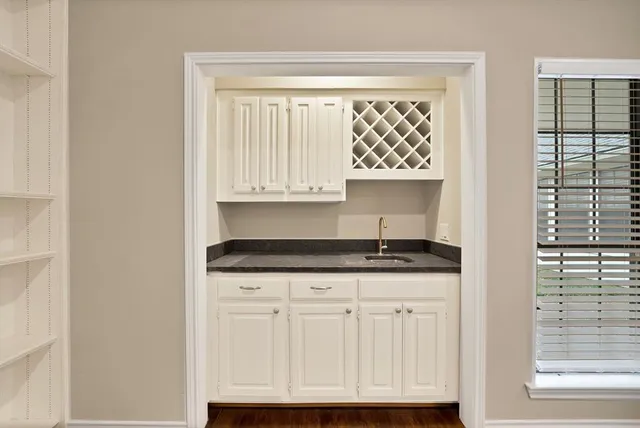 a kitchen with granite countertop a sink and a window