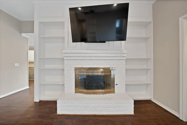 a living room with a fireplace and a flat screen tv