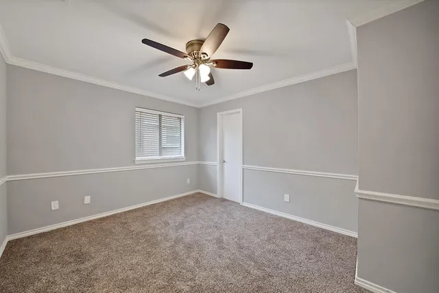 a view of a livingroom with a ceiling fan and window