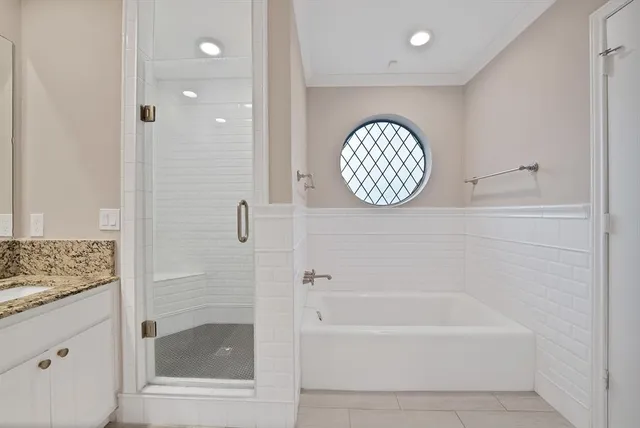 a bathroom with a bathtub and a shower
