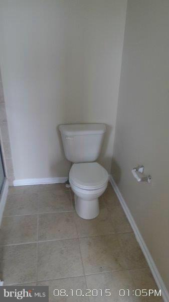 892 Lowe Road Baltimore, MD 21220 - Photo 11 of 19 a white toilet sitting next to a bathroom sink