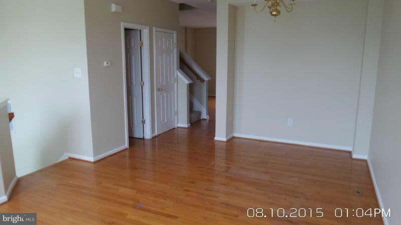 892 Lowe Road Baltimore, MD 21220 - Photo 4 of 19 a view of an empty room with wooden floor and closet