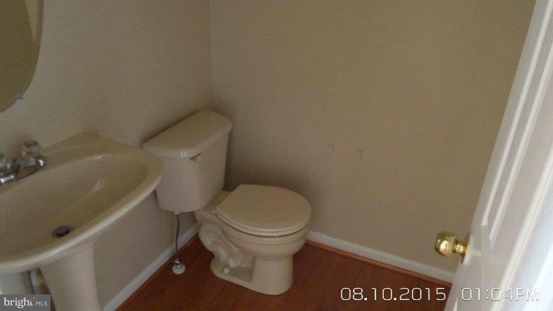 892 Lowe Road Baltimore, MD 21220 - Photo 5 of 19 a white toilet sitting next to a shower