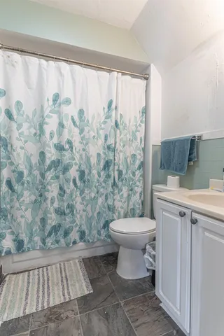 a bathroom with a toilet sink and shower