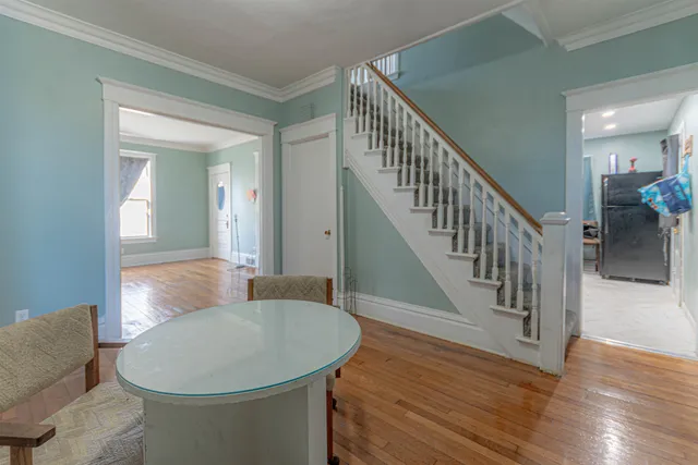 a view of livingroom and dining room with wooden floor
