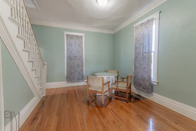 a view of a room with wooden floor and chair