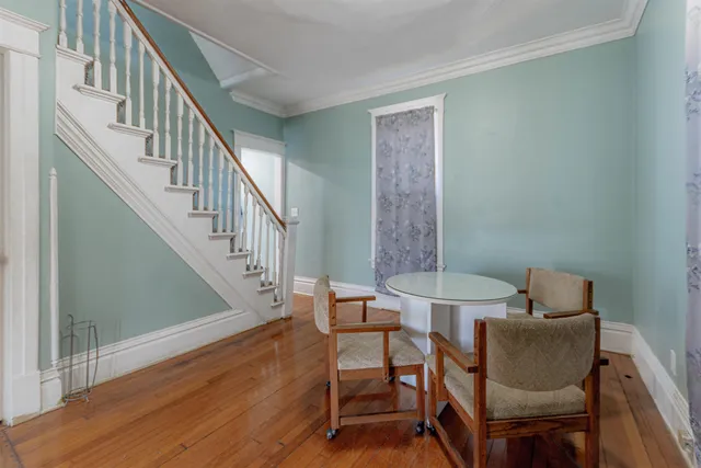 a view of a room with furniture and wooden floor