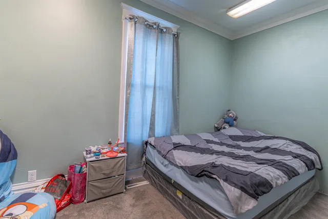 a bedroom with a bed and a table in it