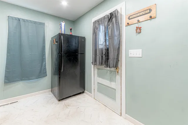 a view of a hallway with closet and a bathroom