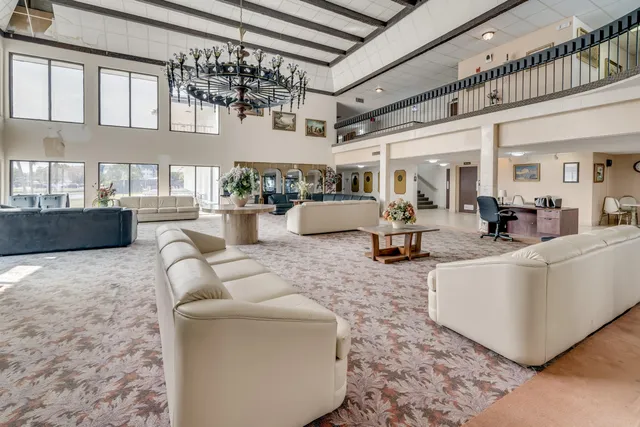 a living room with furniture and a chandelier