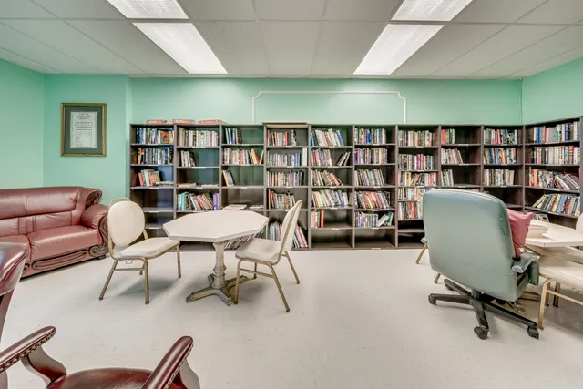 a view of a livingroom with furniture and a bookshelf