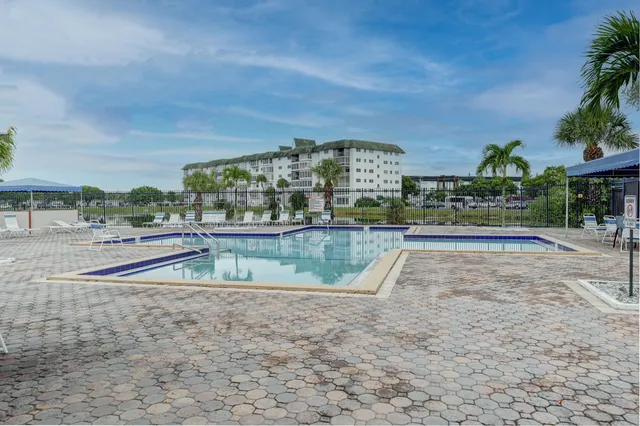 a view of swimming pool with outdoor seating and plants