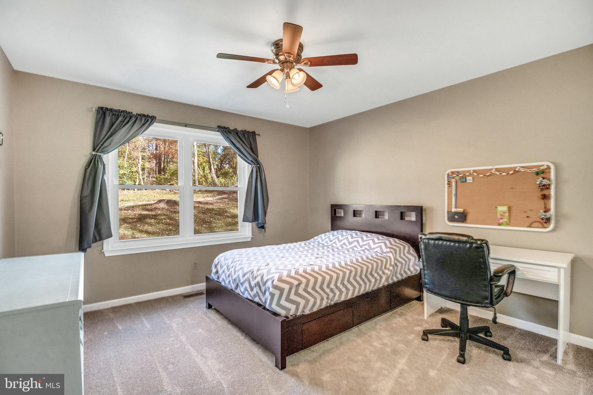 920 Carson Road Huntingtown, MD 20639 - Photo 12 of 32 a bedroom with a bed and a chair